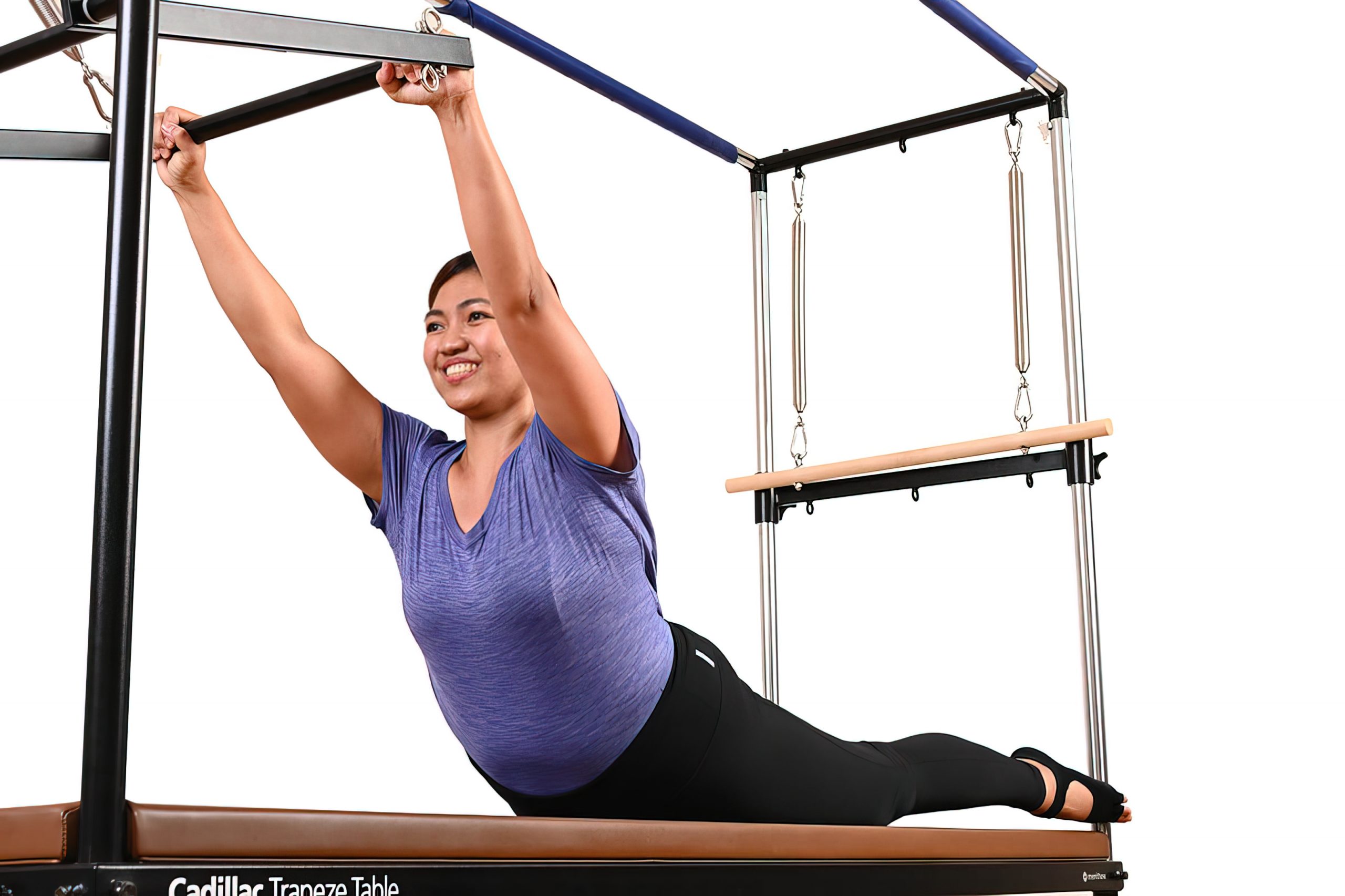 A skilled All Core Pilates instructor is seen demonstrating an exercise on a Pilates reformer machine.