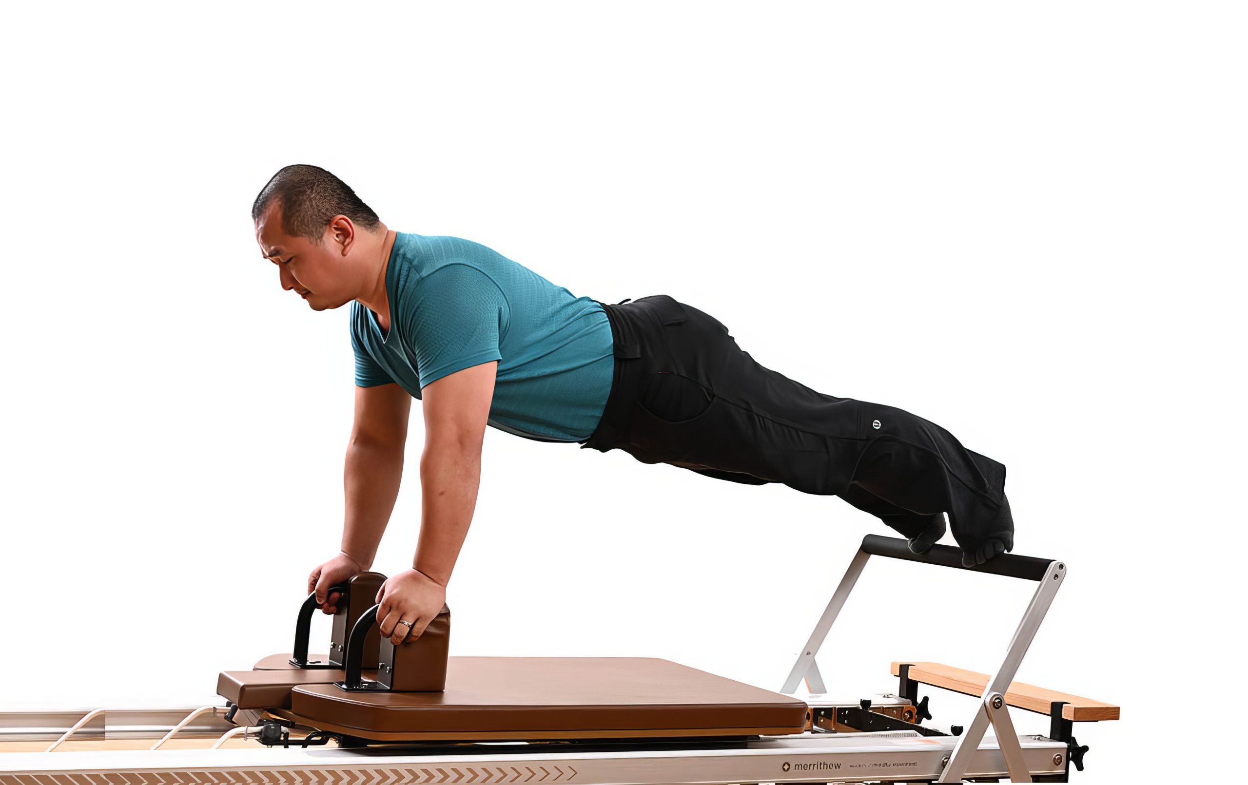 An All Core Pilates Instructor doing a Pilates pose on a Merrithew Reformer exercise machine
