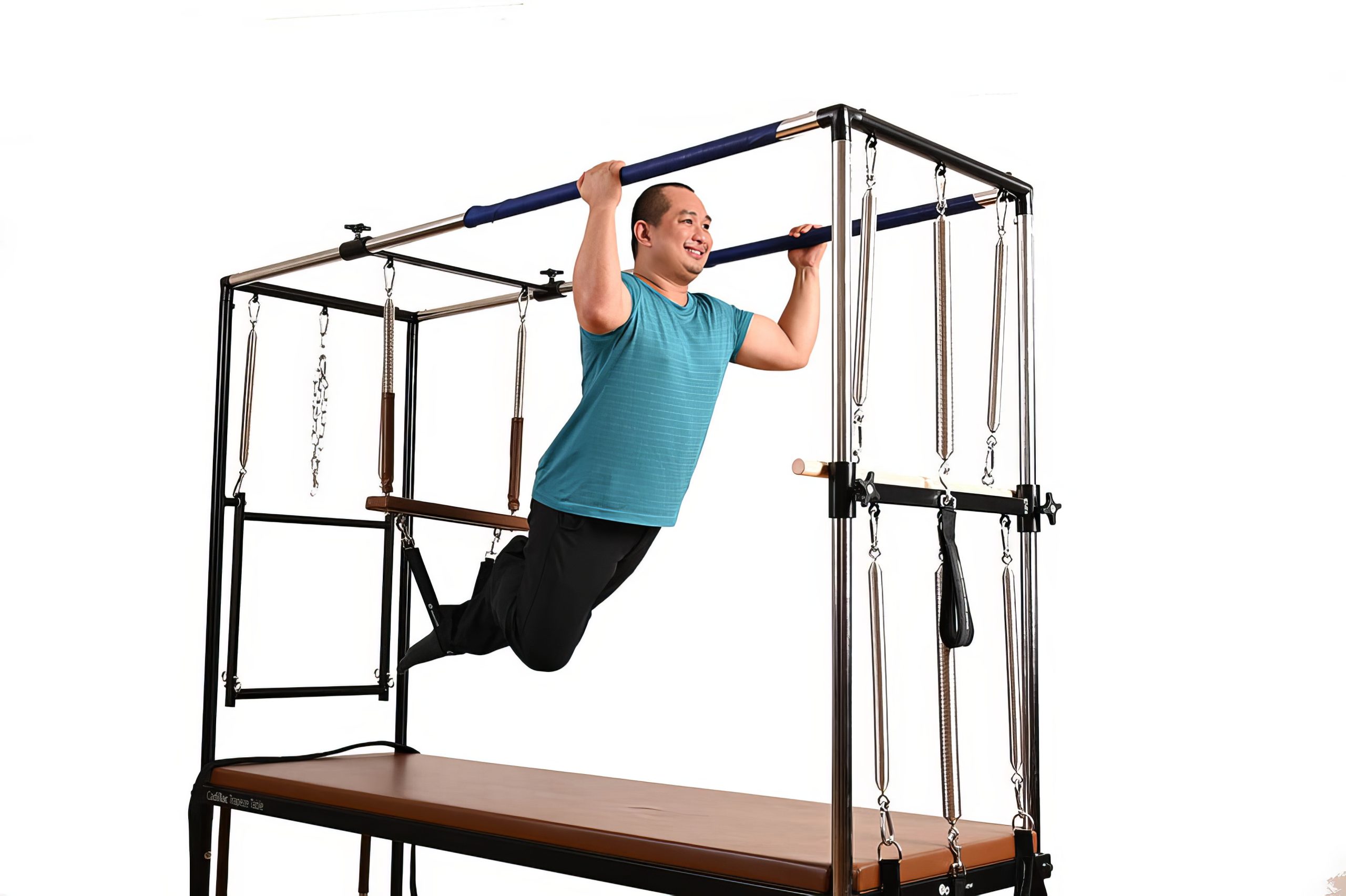 An All Core Pilates Instructor doing a Pilates pose on a Cadillac Reformer exercise machine